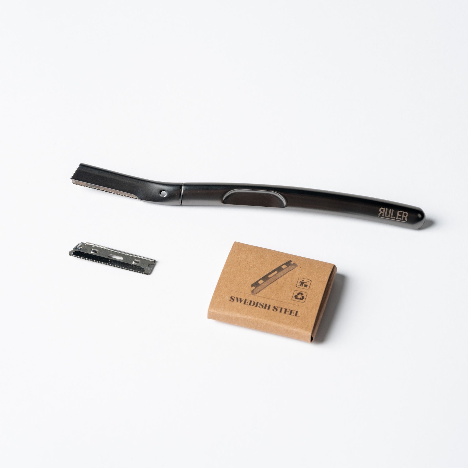 Replacement razor blades shown with metal handle to illustrate fit